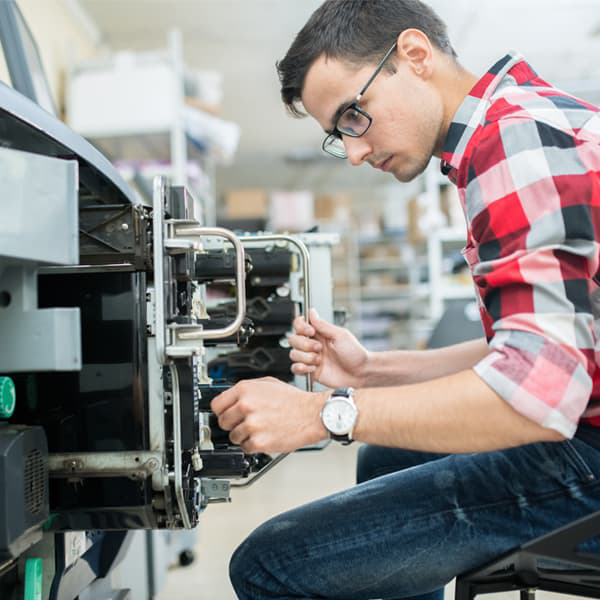 Service technician repairing a laser printer.